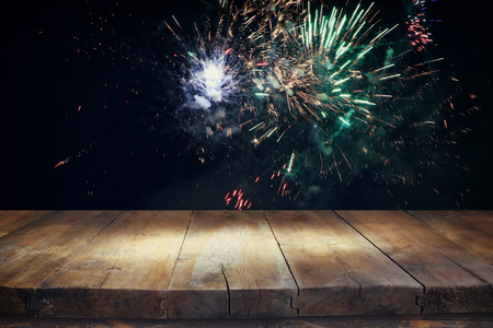 Empty wooden table in front of fireworks background. Product display montageの写真素材