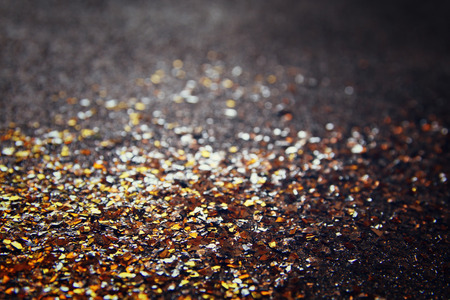 glitter vintage lights background. gold and black. de focused.の写真素材