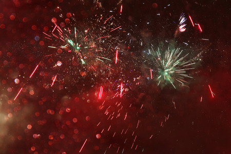 abstract holiday background, glitter lights and firework overlay.の写真素材