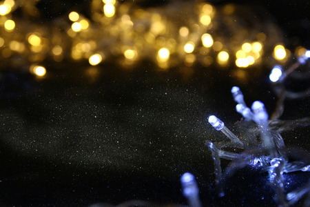 Abstract image of Christmas garland lights on glitter background. Selective focus