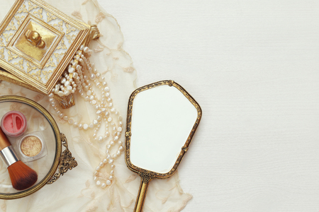 Top view image of vintage woman toilet fashion objects on wooden tableの写真素材