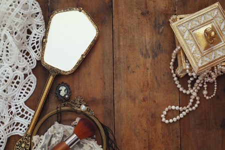 Top view image of vintage woman toilet fashion objects on old wooden tableの写真素材