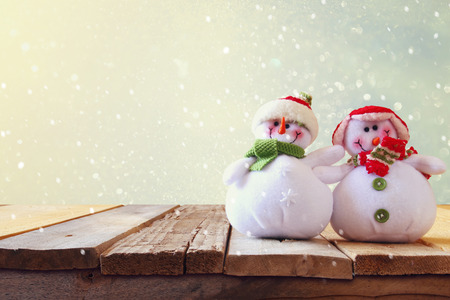 Cute snowmen on wooden table.の写真素材
