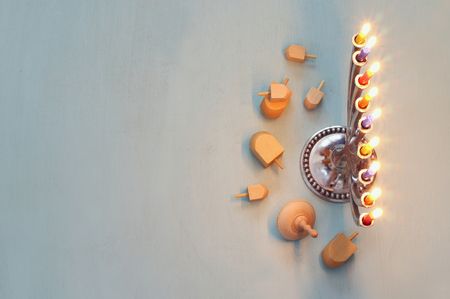 Top view Image of jewish holiday Hanukkah with menorah (traditional Candelabra) and wooden dreidel (spinning top). Selective focusの写真素材