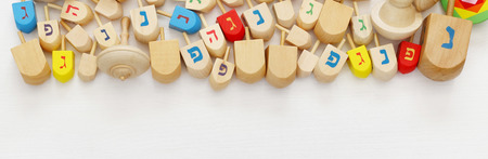 Image of jewish holiday Hanukkah with wooden dreidels (spinning top). Wide formatの写真素材