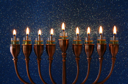 Low key Image of jewish holiday Hanukkah background with menorah (traditional candelabra) and burning candlesの写真素材