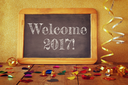 blackboard and colorful cinfetti on wooden table.の写真素材