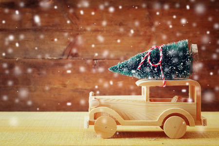 Wooden car carrying a christmas tree.の写真素材