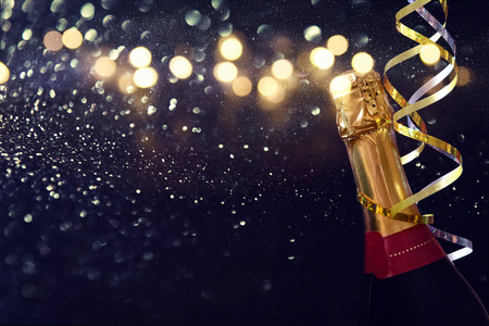 Abstract image of champagne bottle and festive lights. New year and celebration concept