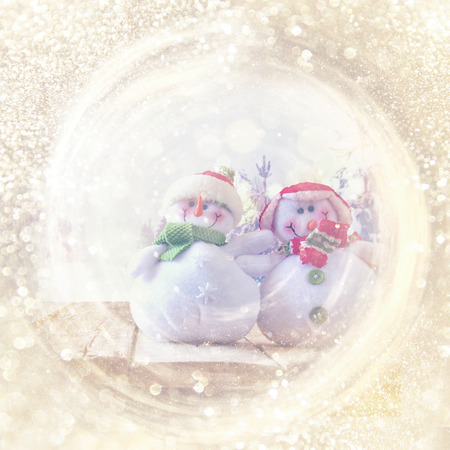 abstract glitter lights background with christmas snowman. de-focusedの写真素材