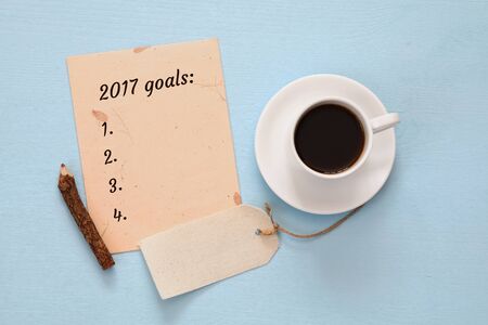 Top view 2017 goals list with notebook, cup of coffee on wooden deskの写真素材