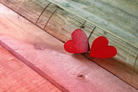Valentines day background. Couple of red hearts on wooden tableの写真素材