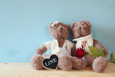 Valentines day concept. Couple of cute teddy bears sitting on wooden tableの写真素材