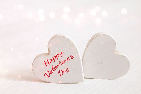 Valentines day background. Couple of white wooden hearts. Glitter overlayの写真素材