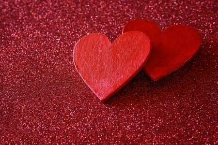 Valentines day background. Wooden red hearts on red shiny backgroundの写真素材