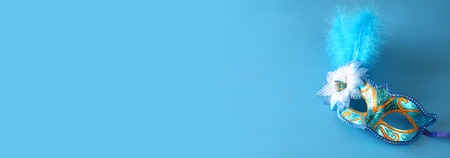 elegant venetian mask on blue wooden background.の写真素材