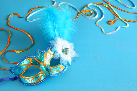 elegant venetian mask on blue wooden background.の写真素材
