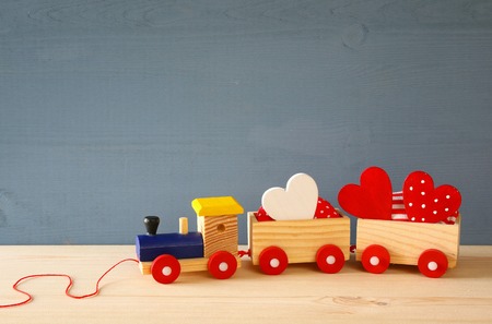 Wooden toy train with herts on the table.の写真素材
