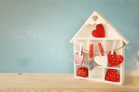 Valentines day background. Wooden house with many hearts on the tableの写真素材