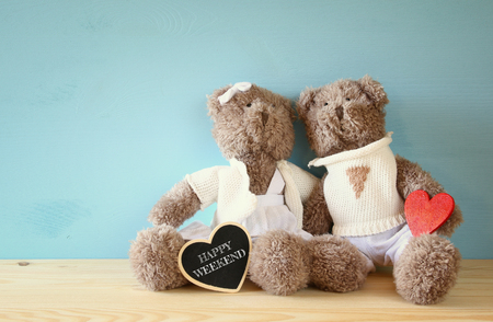 Valentines day concept. Couple of cute teddy bears sitting on wooden tableの写真素材