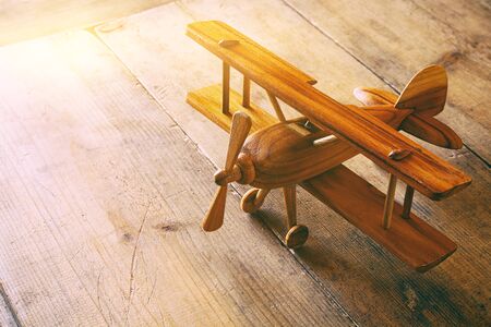 image of vintage old toy airplane over old table. Filtered imageの写真素材