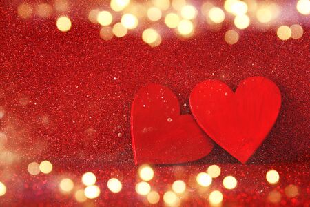 Valentines day background. Wooden red hearts on red shiny backgroundの写真素材