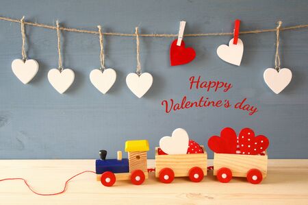 Wooden toy train with hearts on the table.の写真素材