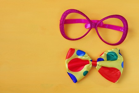 festival retro pink eyeglasses on yellow wooden background. Top viewの写真素材