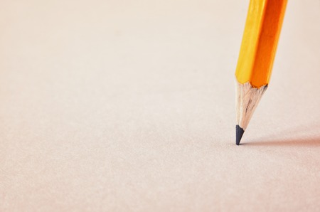 Image of sharp pencil on the blank white paper. Retro filtered
