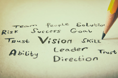 close up image of pecil and handwrittn word VISION over paperの写真素材