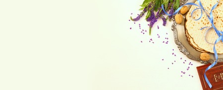 Pesah celebration concept (jewish Passover holiday). Traditional book with text in hebrew: Passover...