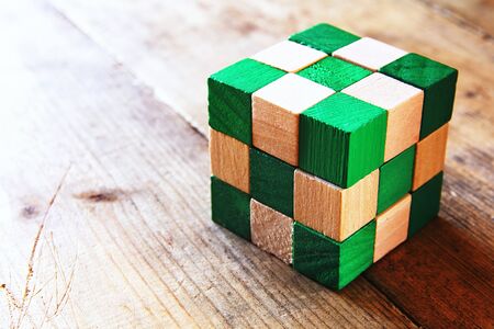 image of square wooden cube puzzle, over wooden table.の写真素材