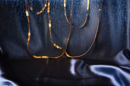 Elegant soft blue silk background with gold sparkle sequinsの写真素材