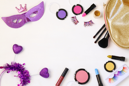 Top view image of carnival makeup on white wooden backgroundの写真素材