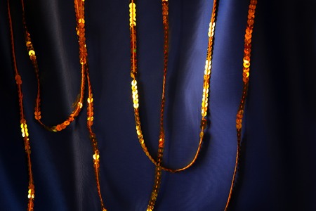Elegant soft blue silk background with gold sparkle sequinsの写真素材
