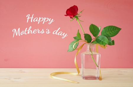 mother's day concept with rose on pink wooden backgroundの写真素材
