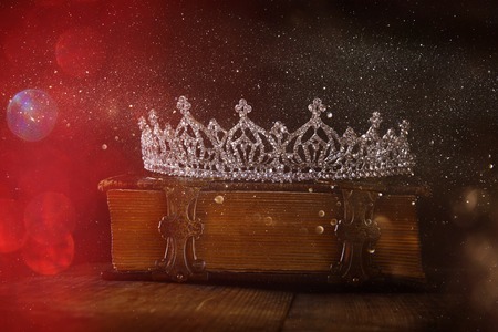 low key image of beautiful diamond queen crown on old book. vintage filtered. selective focus. medieval period conceptの写真素材