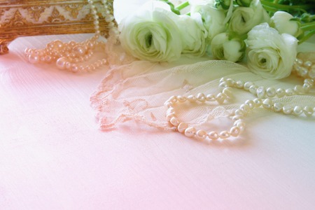 Background of white delicate lace fabric and white flowersの写真素材