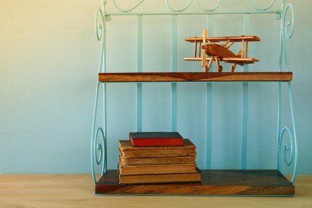 Vintage shelf with old wooden plane toy and books.の写真素材