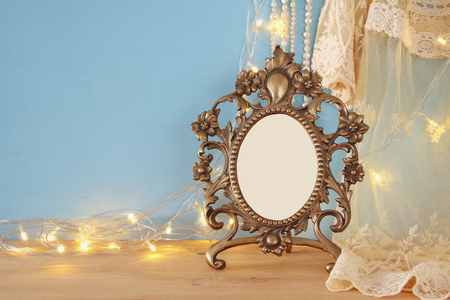 Antique blank victorian style frame on wooden table. template, ready to put photographyの写真素材