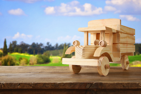 old wooden toy truck car over wooden table. nostalgia and simplicity concept. vintage style imageの写真素材