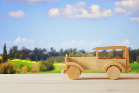 Vintage wooden toy car over wooden table. Nostalgia and simplicity conceptの写真素材