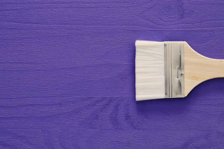 Top view image of paint brush on purple wooden backgroundの写真素材
