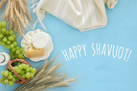 Top view image of dairy products and fruits on wooden background. Symbols of jewish holiday - Shavuotの写真素材
