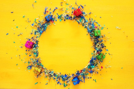 party yellow background with colorful confetti.の写真素材