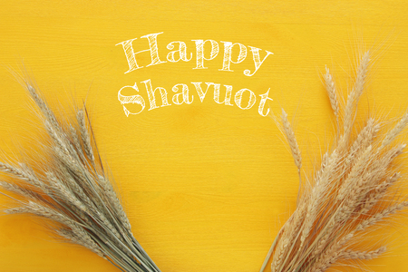 top view of wheat crop on wooden table. Symbols of jewish holiday - Shavuotの写真素材
