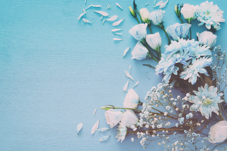 Top view of beautiful and delicate blue flowers arrangement on wooden background. Copy spaceの写真素材