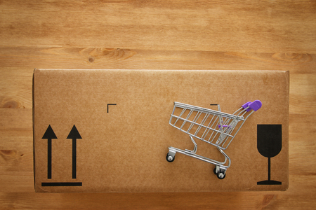Shopping cart on the top of the package box.の写真素材