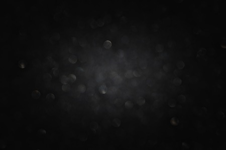 glitter vintage lights background. light silver and black. defocused.の写真素材