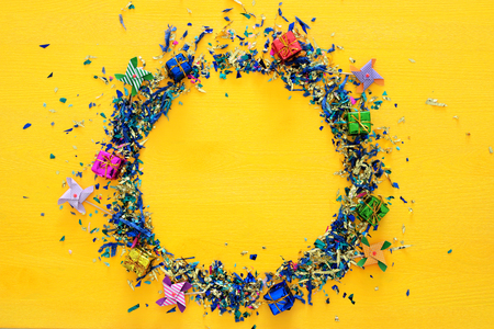 party yellow background with colorful confetti.の写真素材